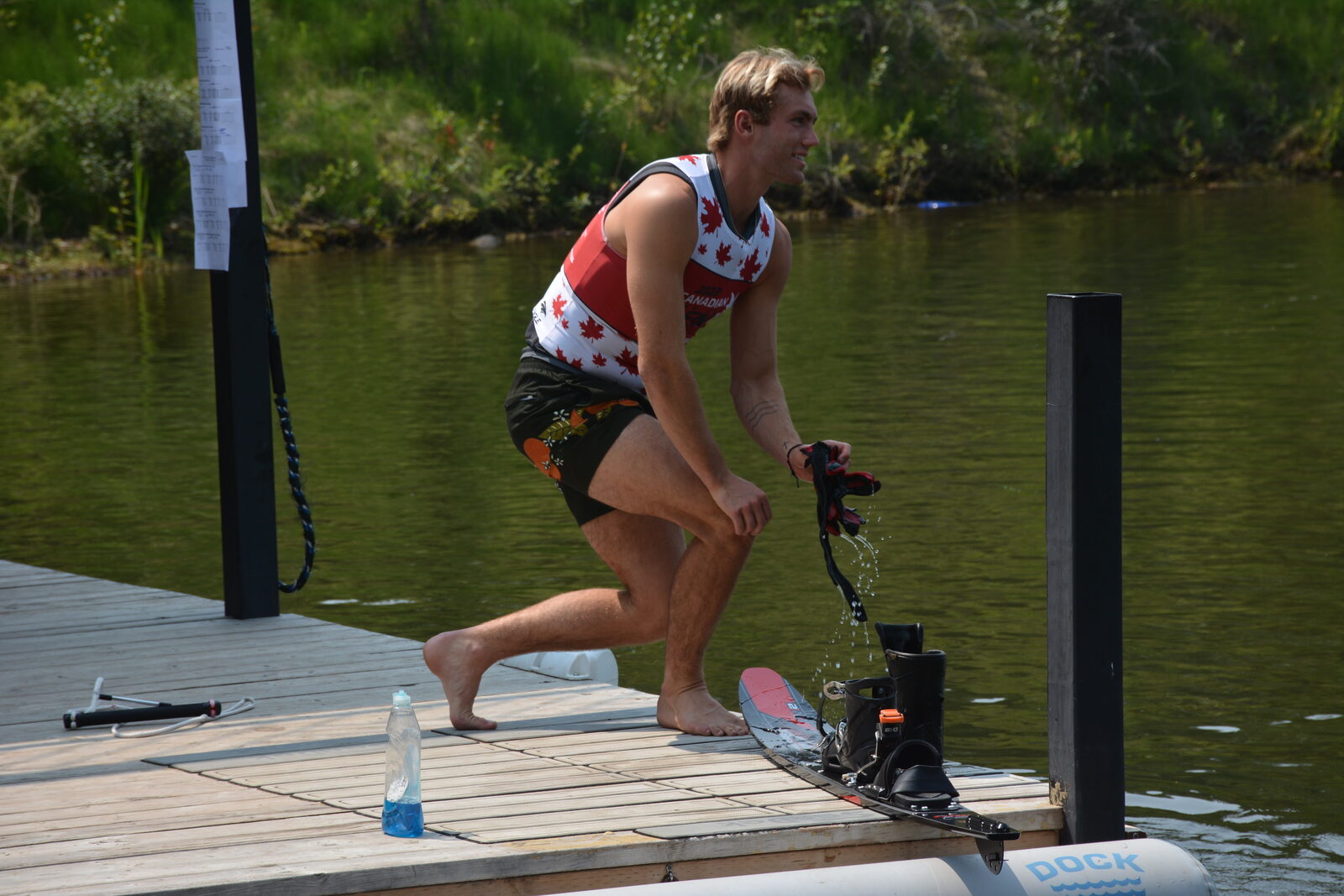 Sean Kraus in Team Canada gear preparing his trick ski on the Shalom Park dock